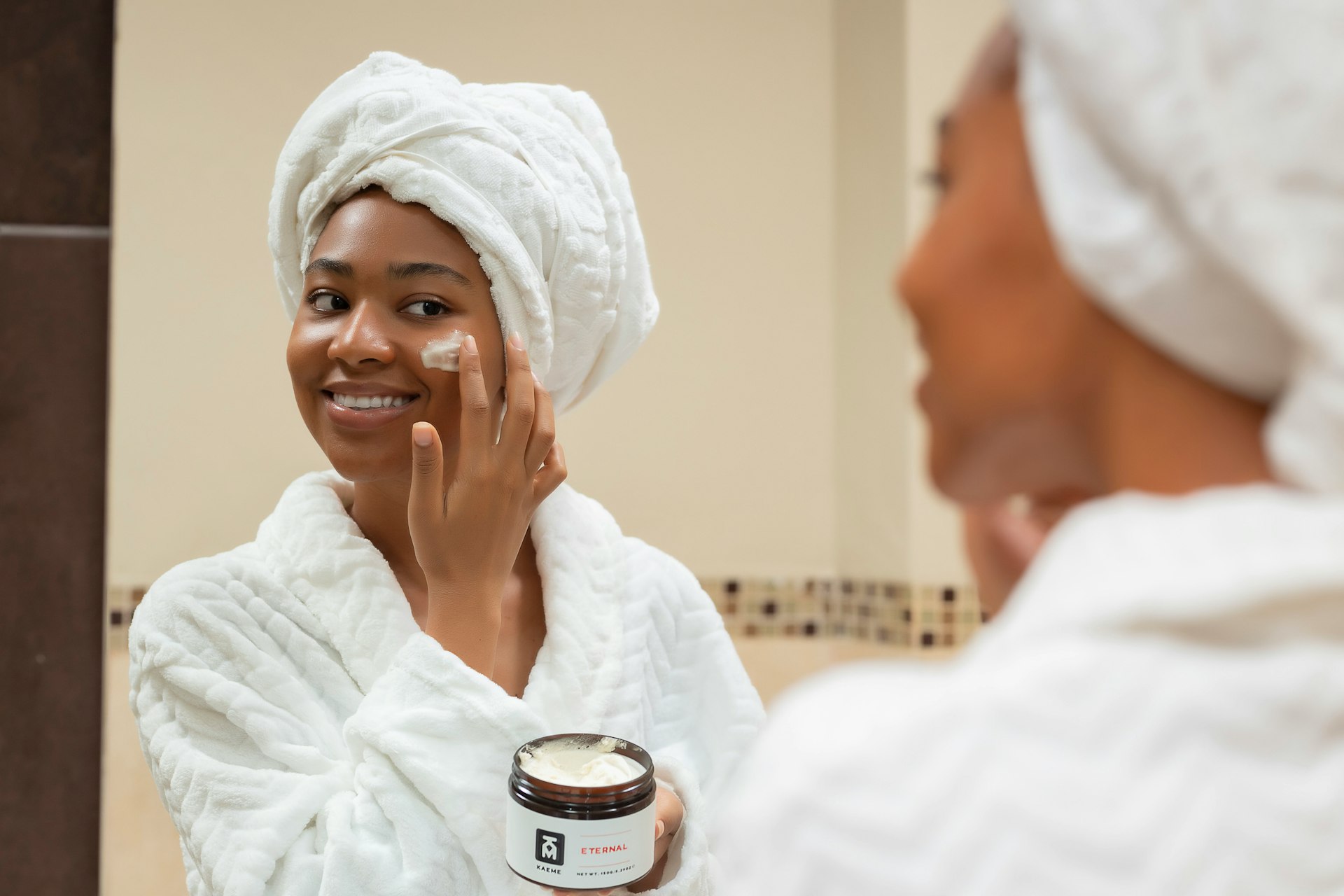 Woman applying face cream - authentic skincare in Douala, Cameroon